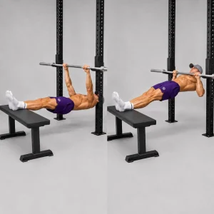 Kal performing an inverted row beneath a fixed bar with his heels elevated on a bench