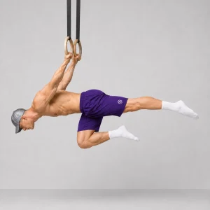 Kal holding a one-leg back lever from a pull-up bar with one leg straight and the other knee tucked